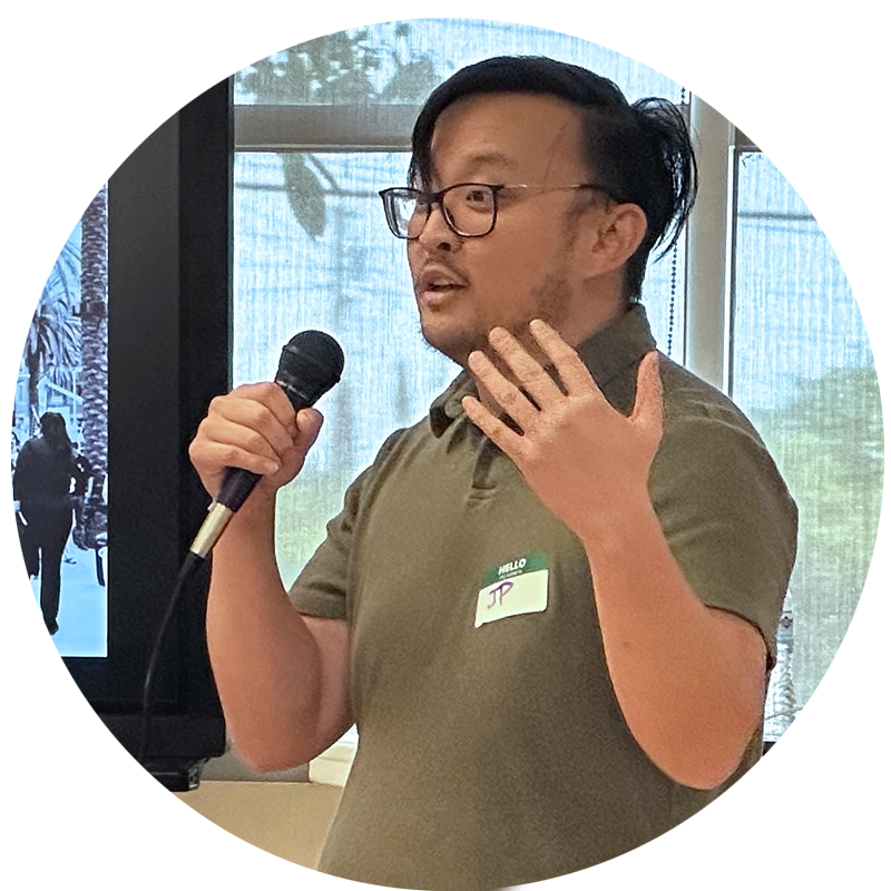 Jonathan Paik speaking into a microphone and gesturing.